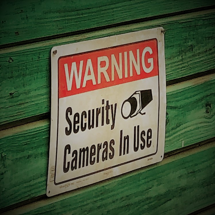 Best practice to post a sign for a surveillance system.